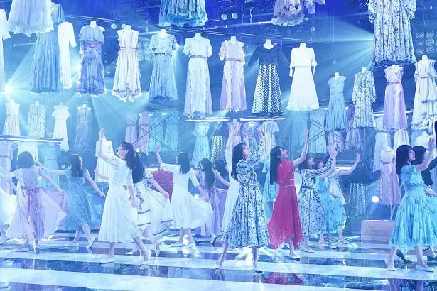 【写真を見る】数々の衣装が飾られたステージで圧倒的なパフォーマンスを披露する乃木坂46