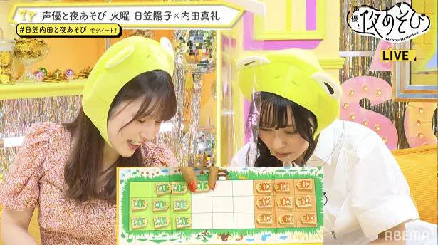 【写真を見る】カエルのかぶり物姿でゲームに挑戦する日笠陽子と内田真礼(写真右から)