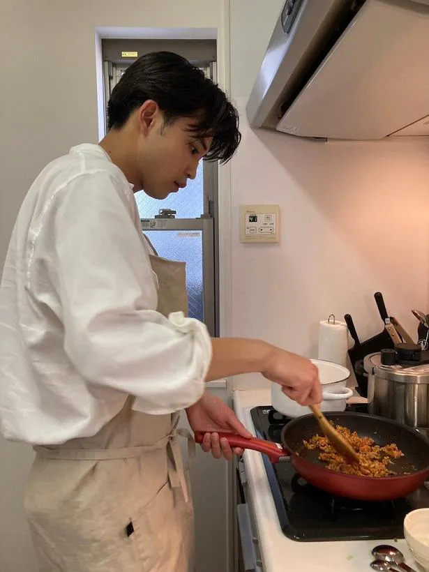 【写真を見る】真剣な表情で料理をしている中田圭祐の横顔ショットを公開した川島海荷