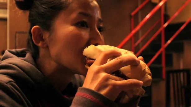 【写真を見る】“旅する鈴木”の鈴木聡子さんがおいしそうにご飯を食べる