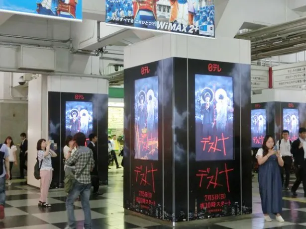 渋谷駅玉川口改札外の10本の柱にあるモニターで「デスノート」の宣伝映像が流れ、通行人も足を止める